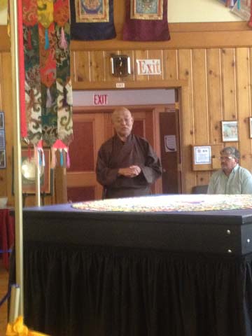 Venerable Lama Losang Samten overlooking the mandala of Buddha Amitahba PHOTO: Gene Savoy Jr.