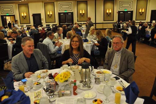 View down row of three tables reserved by International Community of Christ. At front table (from left to right) Dave Asher, Sylvia Ontaneda, Gary Buchanan PHOTO: Stephan Fuelling